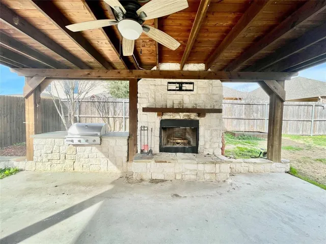 a big room with wooden floor and a fireplace