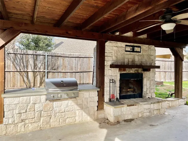 a living room with a fireplace a rug and a large window