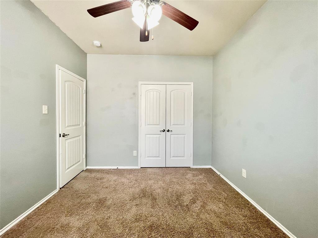 1005 Lake Woodland Drive Little Elm, TX 75068 - Photo 23 of 37 Unfurnished bedroom with carpet, a closet, and ceiling fan