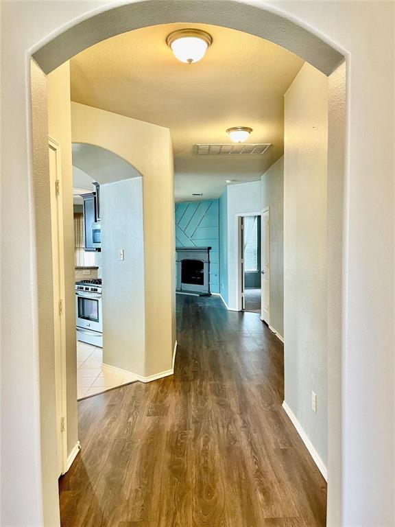 1005 Lake Woodland Drive Little Elm, TX 75068 - Photo 29 of 37 Hall featuring arched walkways and dark wood-style floors