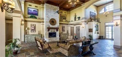 a living room with fireplace furniture and a fireplace