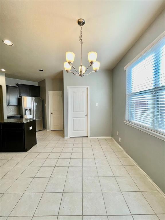1005 Lake Woodland Drive Little Elm, TX 75068 - Photo 7 of 37 Kitchen featuring dark cabinetry, light tile patterned flooring, and recessed lighting