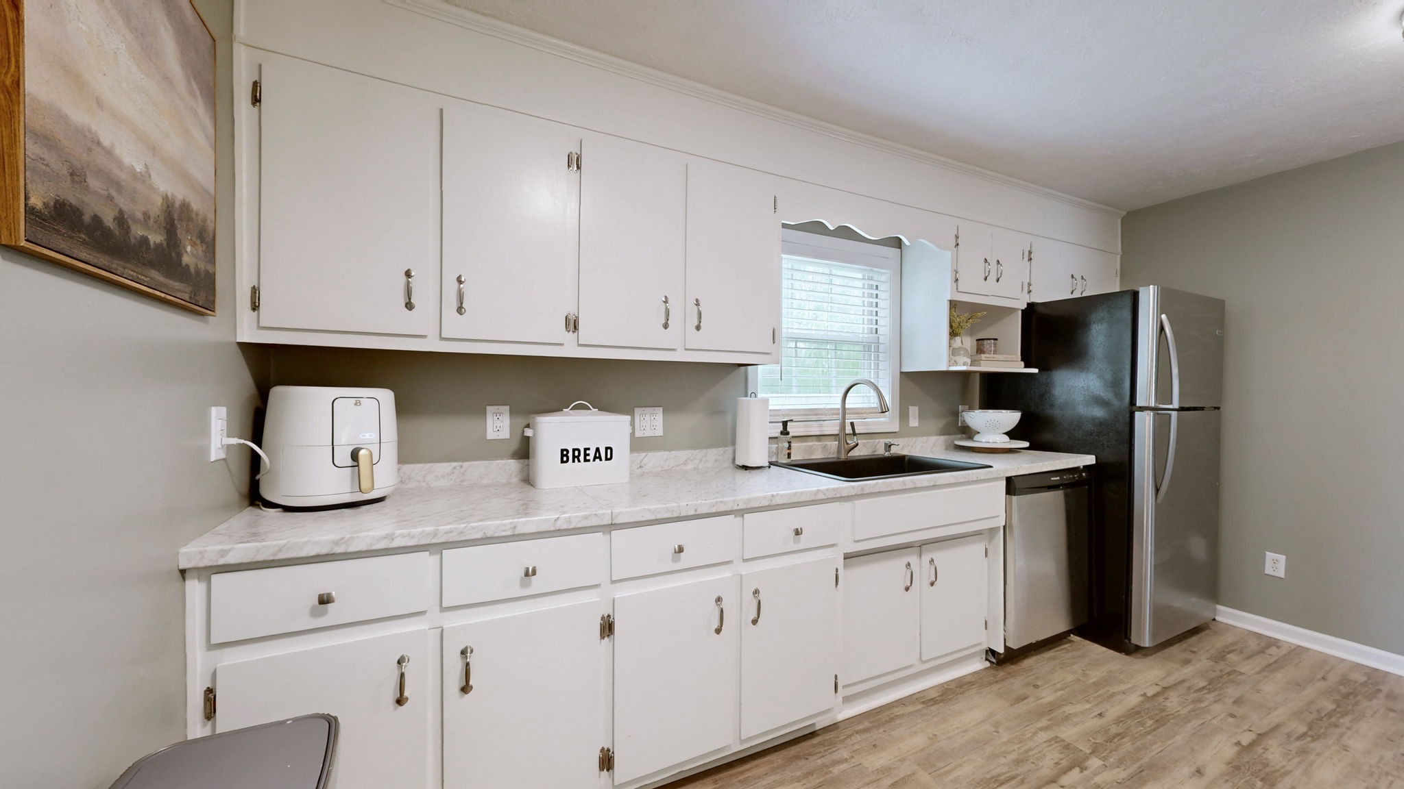 904 West Market Street Decherd, TN 37324 - Photo 7 of 26 a kitchen with stainless steel appliances granite countertop a sink stove refrigerator and cabinets
