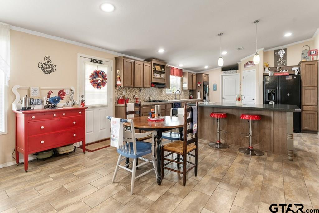 12350 County Road 2911 Eustace, TX 75124 - Photo 16 of 43 a kitchen view with stainless steel appliances kitchen island granite countertop a dining table and chairs
