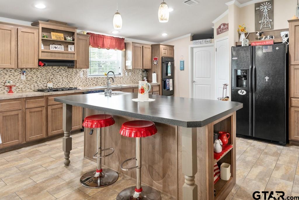 12350 County Road 2911 Eustace, TX 75124 - Photo 17 of 43 a kitchen with stainless steel appliances granite countertop a refrigerator and a sink