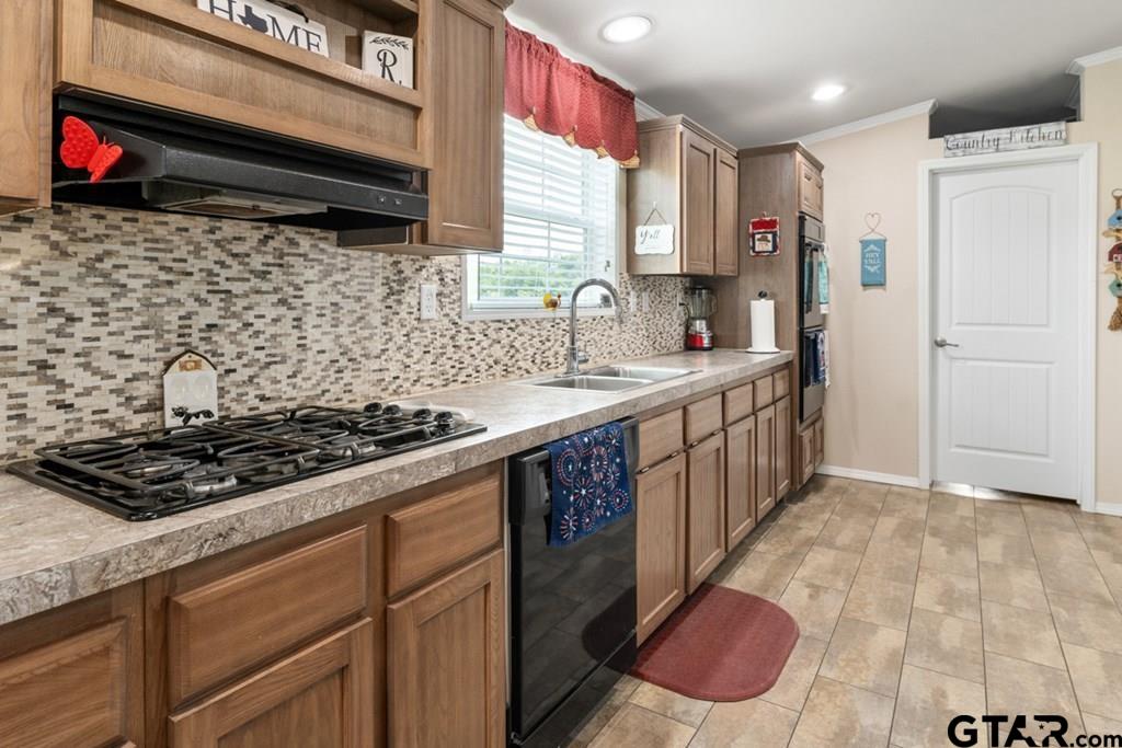 12350 County Road 2911 Eustace, TX 75124 - Photo 18 of 43 a kitchen with stainless steel appliances a stove a sink a refrigerator and cabinets