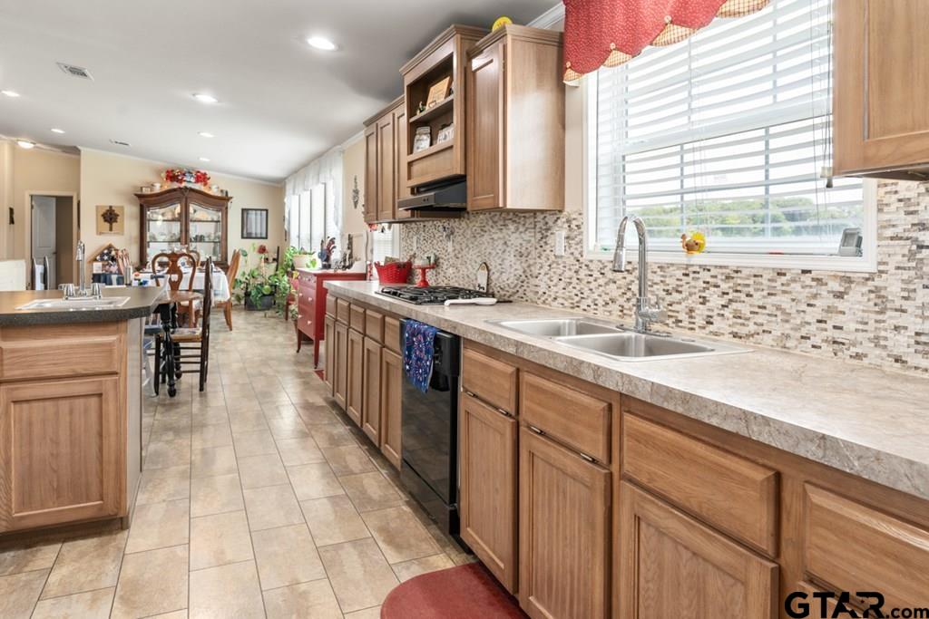 12350 County Road 2911 Eustace, TX 75124 - Photo 20 of 43 a kitchen with stainless steel appliances granite countertop a sink counter space cabinets and a large window