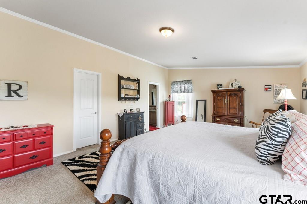 12350 County Road 2911 Eustace, TX 75124 - Photo 27 of 43 a bedroom with a bed and a dresser
