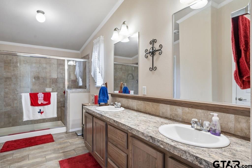 12350 County Road 2911 Eustace, TX 75124 - Photo 28 of 43 a bathroom with a granite countertop sink and a mirror