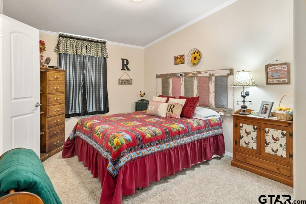 12350 County Road 2911 Eustace, TX 75124 - Photo 30 of 43 a bedroom with a bed and a chandelier