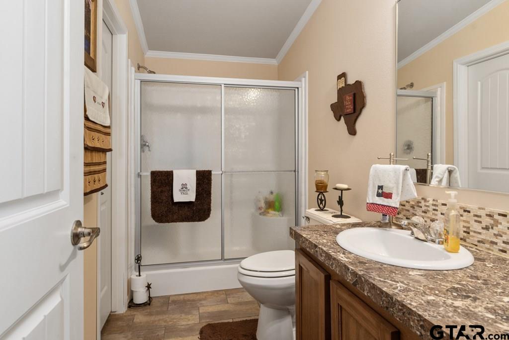 12350 County Road 2911 Eustace, TX 75124 - Photo 34 of 43 a bathroom with a granite countertop sink toilet and shower