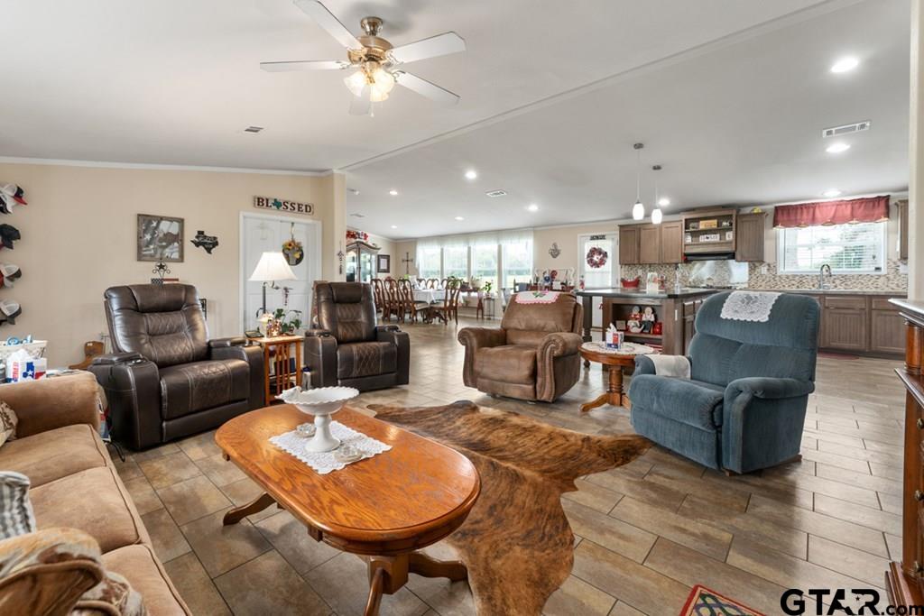 12350 County Road 2911 Eustace, TX 75124 - Photo 8 of 43 a living room with furniture a ceiling fan and a rug