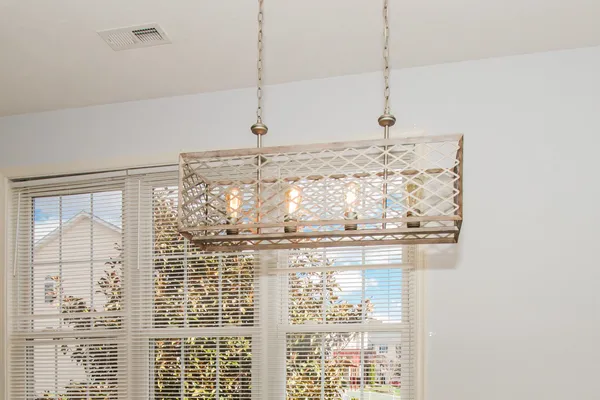 a bathroom with a granite countertop sink and white cabinets