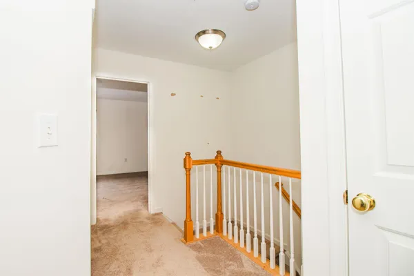 a view of a hallway view with staircase