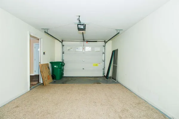 a view of a house with a small yard and wooden fence
