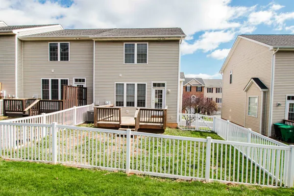 a front view of a house with wooden fence