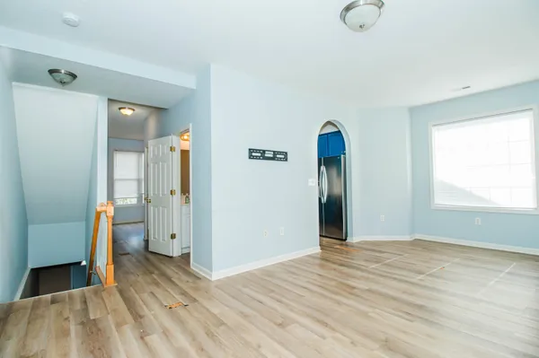 a view of empty room with wooden floor