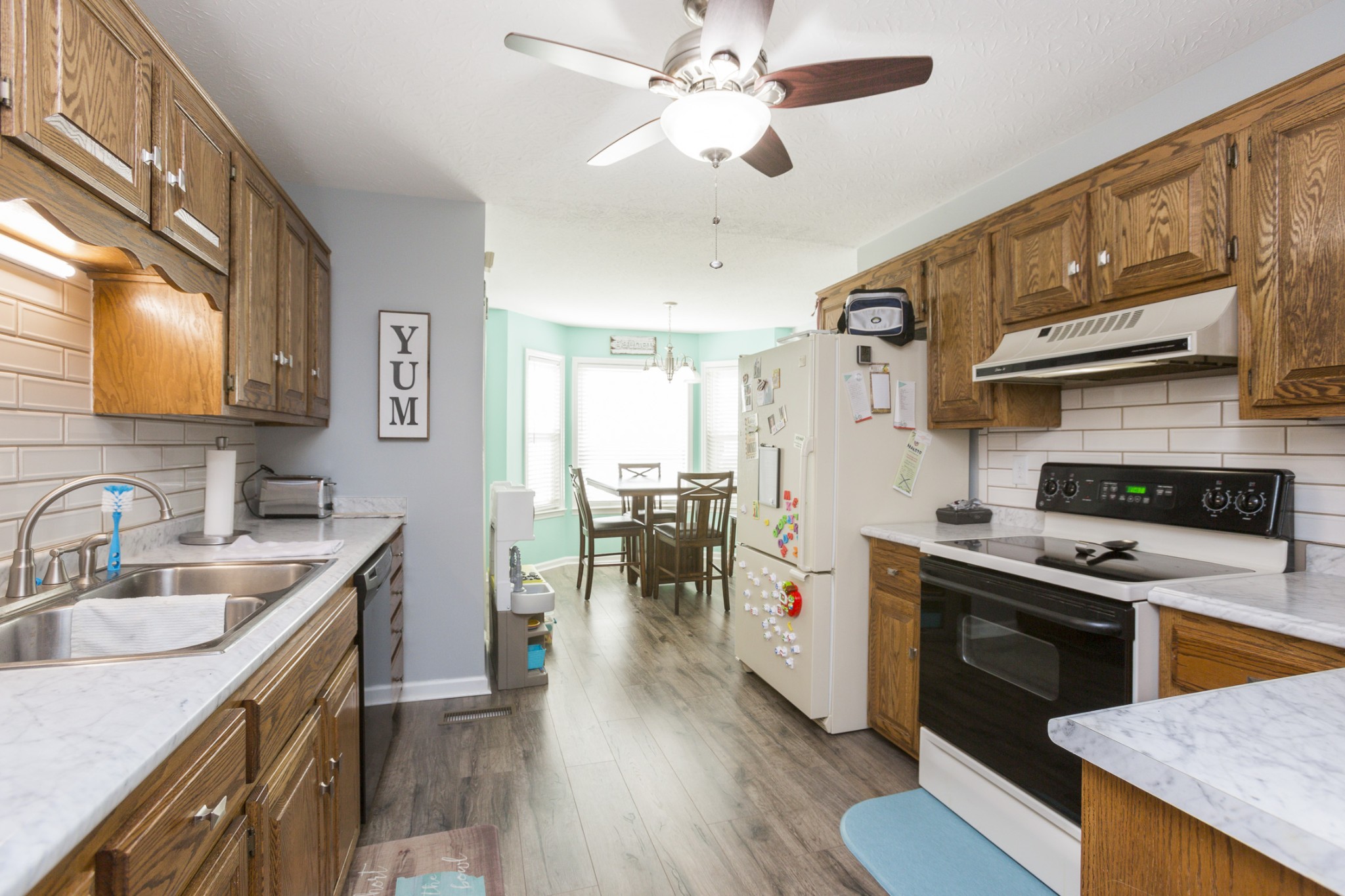6045 Ebenezer Road Greenbrier, TN 37073 - Photo 12 of 30 a kitchen with a stove a sink and a refrigerator
