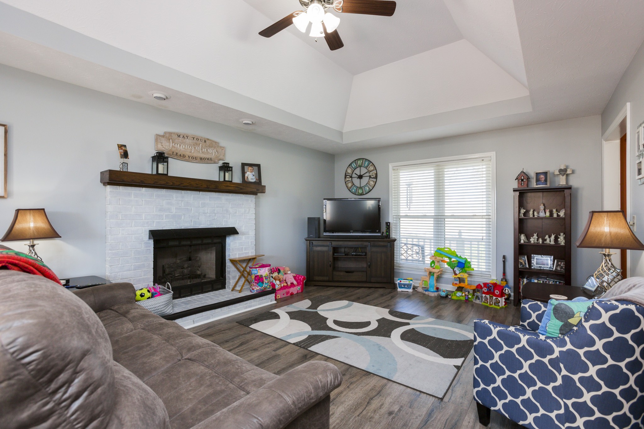 6045 Ebenezer Road Greenbrier, TN 37073 - Photo 7 of 30 a living room with furniture a fireplace and a flat screen tv