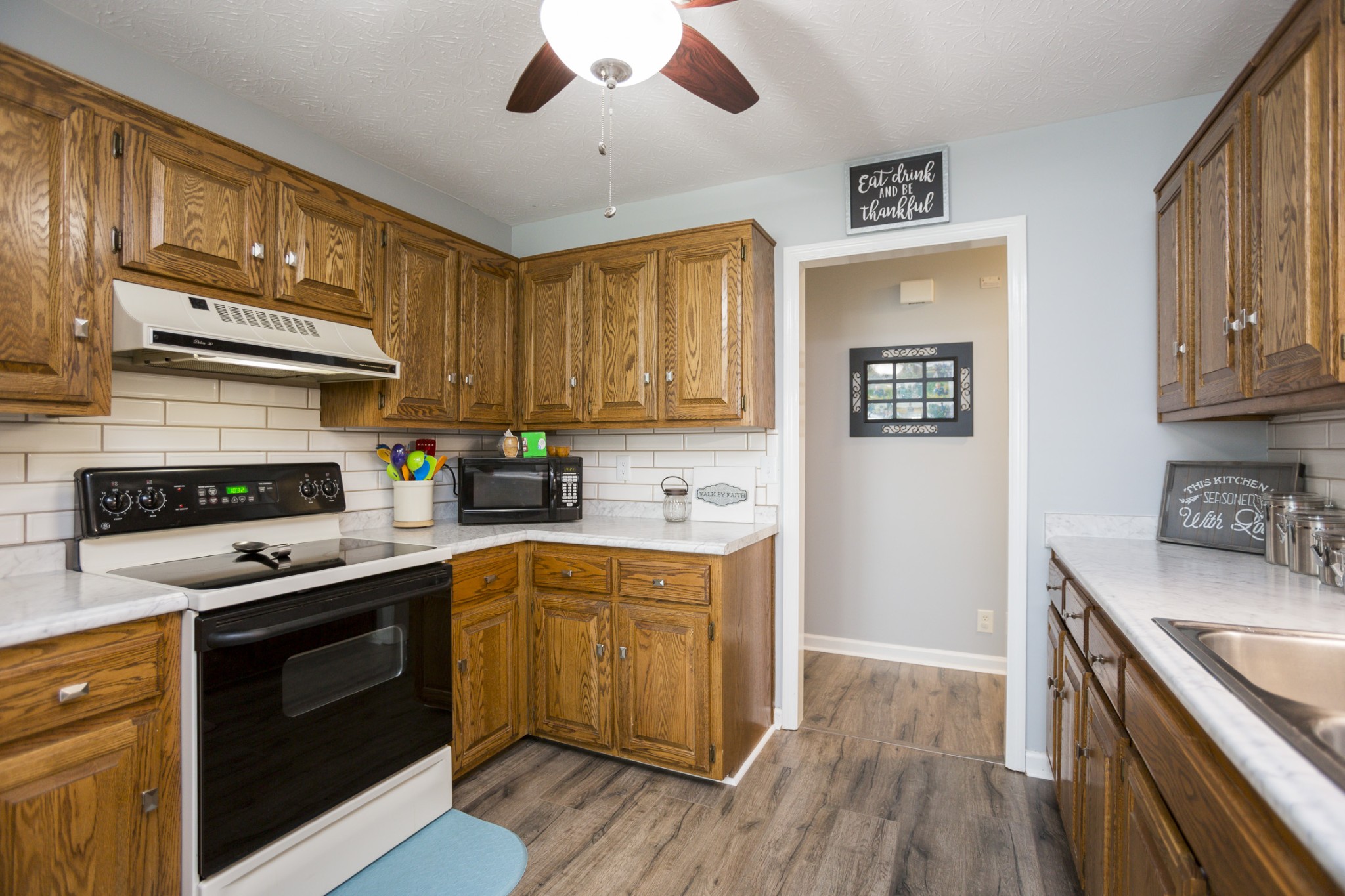 6045 Ebenezer Road Greenbrier, TN 37073 - Photo 9 of 30 a kitchen with stainless steel appliances granite countertop wooden cabinets stove top oven and sink