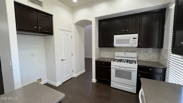 a kitchen with stainless steel appliances a stove and a microwave