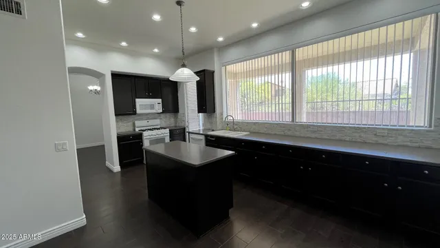 a kitchen with sink cabinets and window