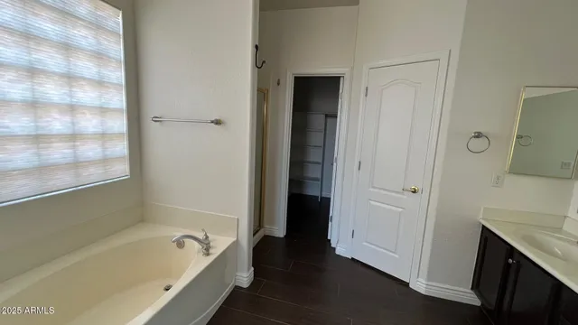 a bathroom with a tub a sink and a shower
