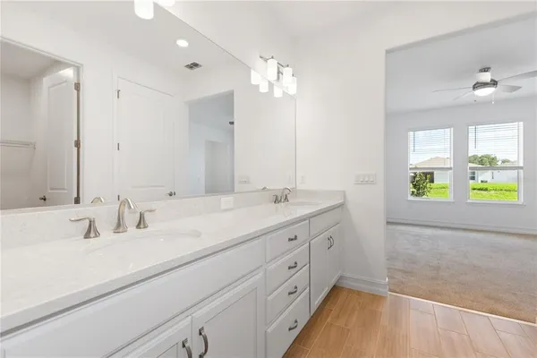 a bathroom with a double vanity sink and a mirror