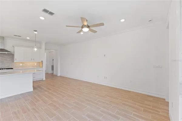 a view of a kitchen with a sink and a refrigerator