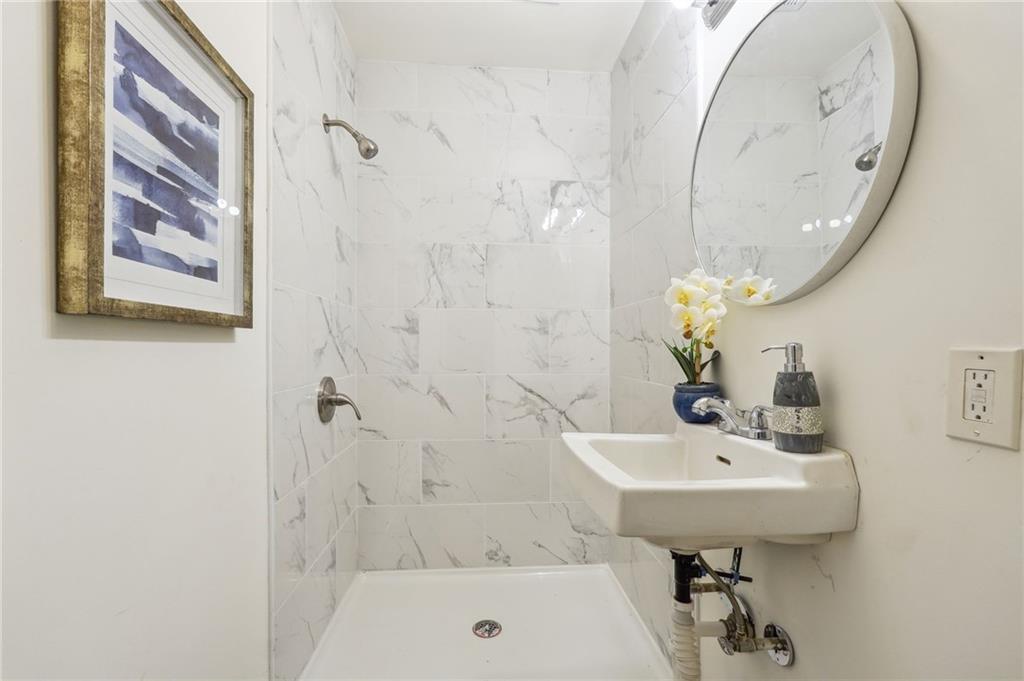 2287 Mulberry Street Atlanta, GA 30344 - Photo 11 of 18 a bathroom with a sink a mirror and a bathtub