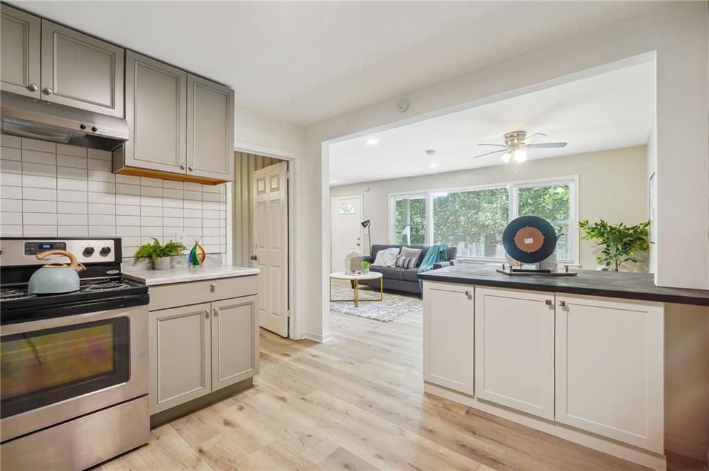 2287 Mulberry Street Atlanta, GA 30344 - Photo 7 of 18 a kitchen with stainless steel appliances granite countertop a stove and a wooden floors