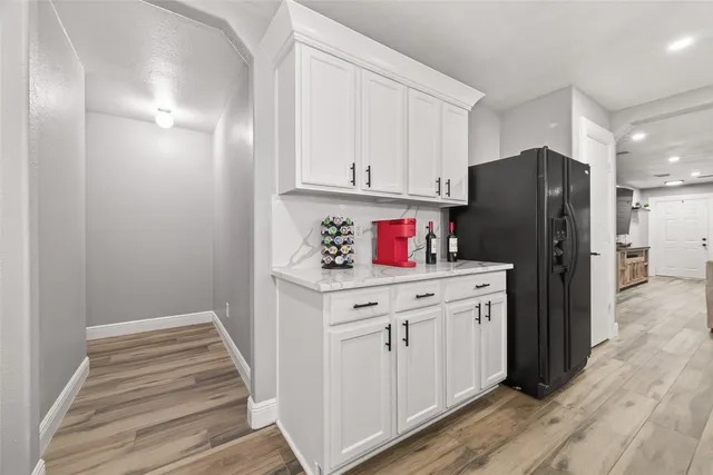 a kitchen with a refrigerator and cabinets