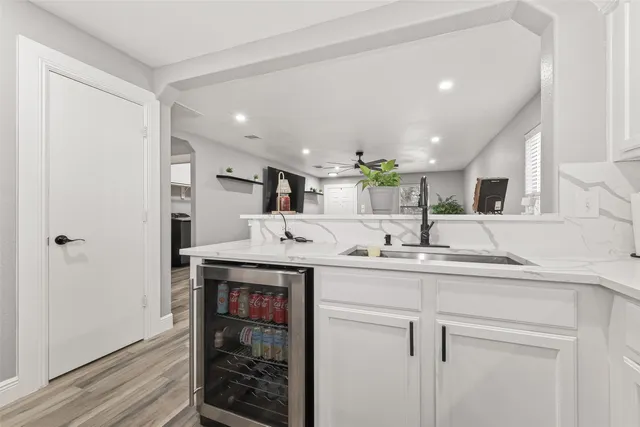 a kitchen with kitchen island a sink stainless steel appliances and cabinets