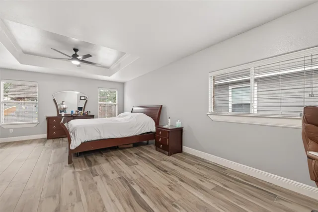 a bedroom with a bed and wooden floor
