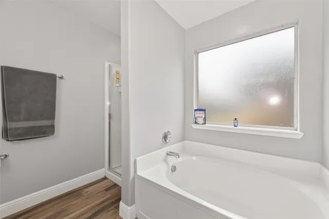 a bathroom with a bathtub and a window