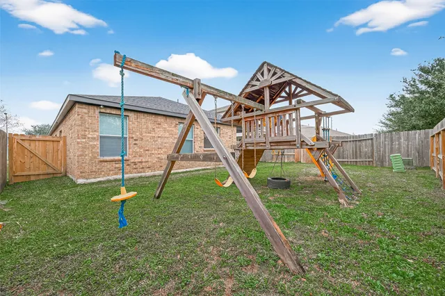 a house with green field in front of it
