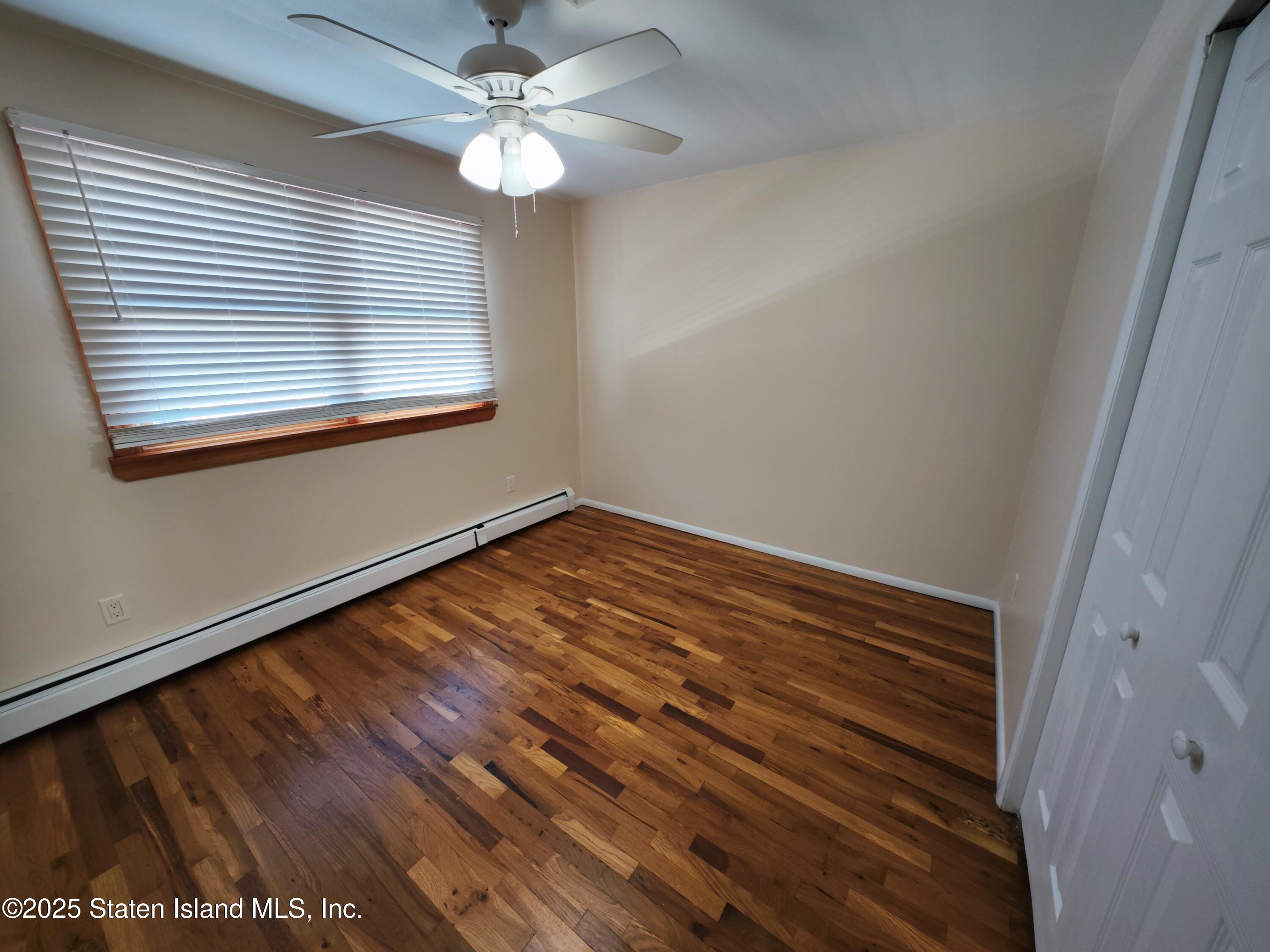 517 Rathbun Avenue Staten Island, NY 10312 - Photo 11 of 28 a view of room with window and ceiling fan