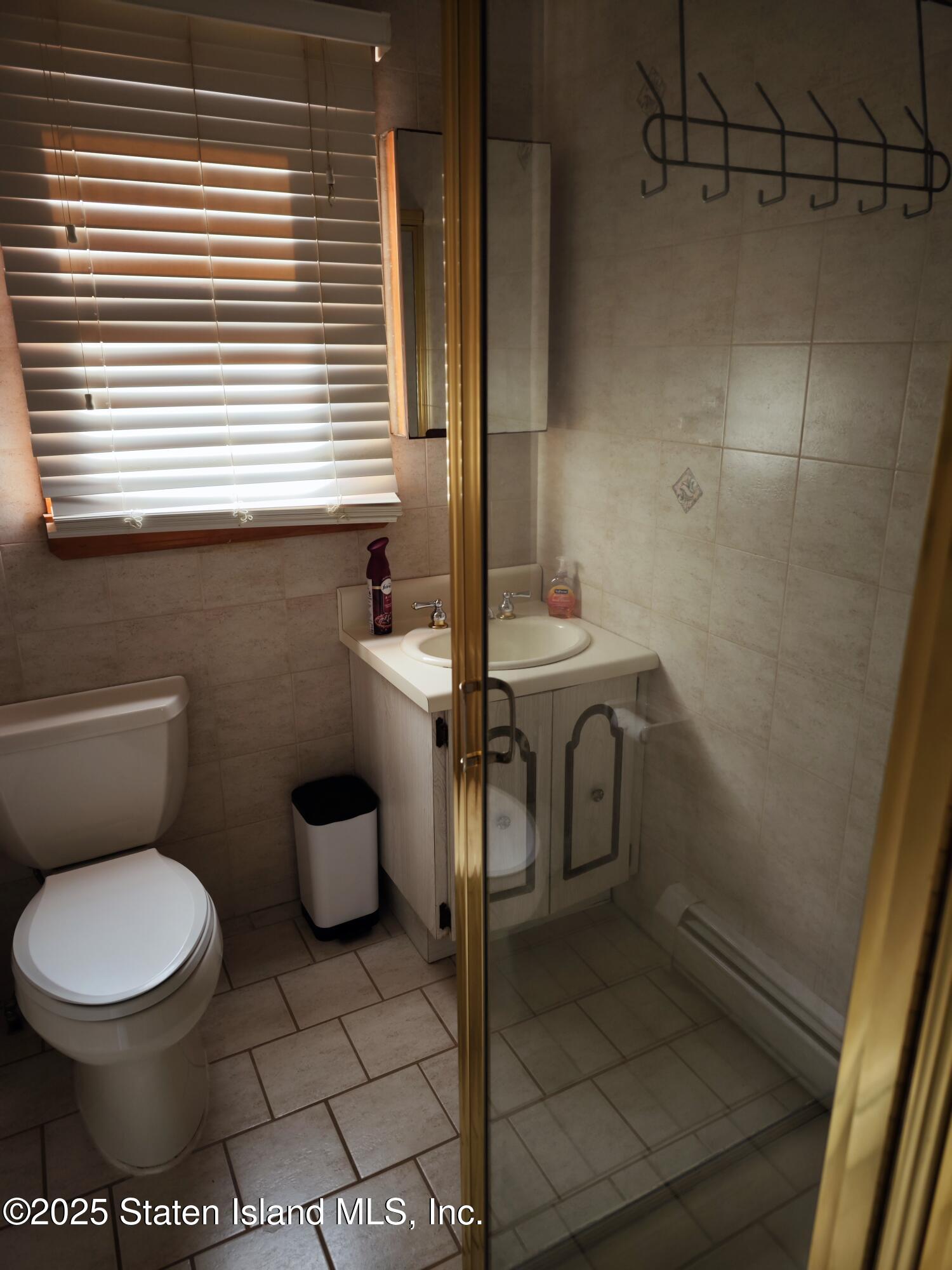 517 Rathbun Avenue Staten Island, NY 10312 - Photo 14 of 28 a bathroom with a toilet and a sink