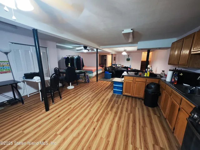 a living room with lots of furniture and wooden floor