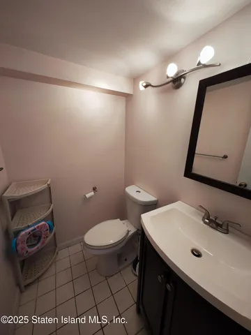 a bathroom with a sink toilet and mirror