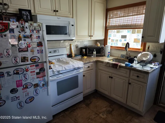 a kitchen with stainless steel appliances a stove a sink and a microwave
