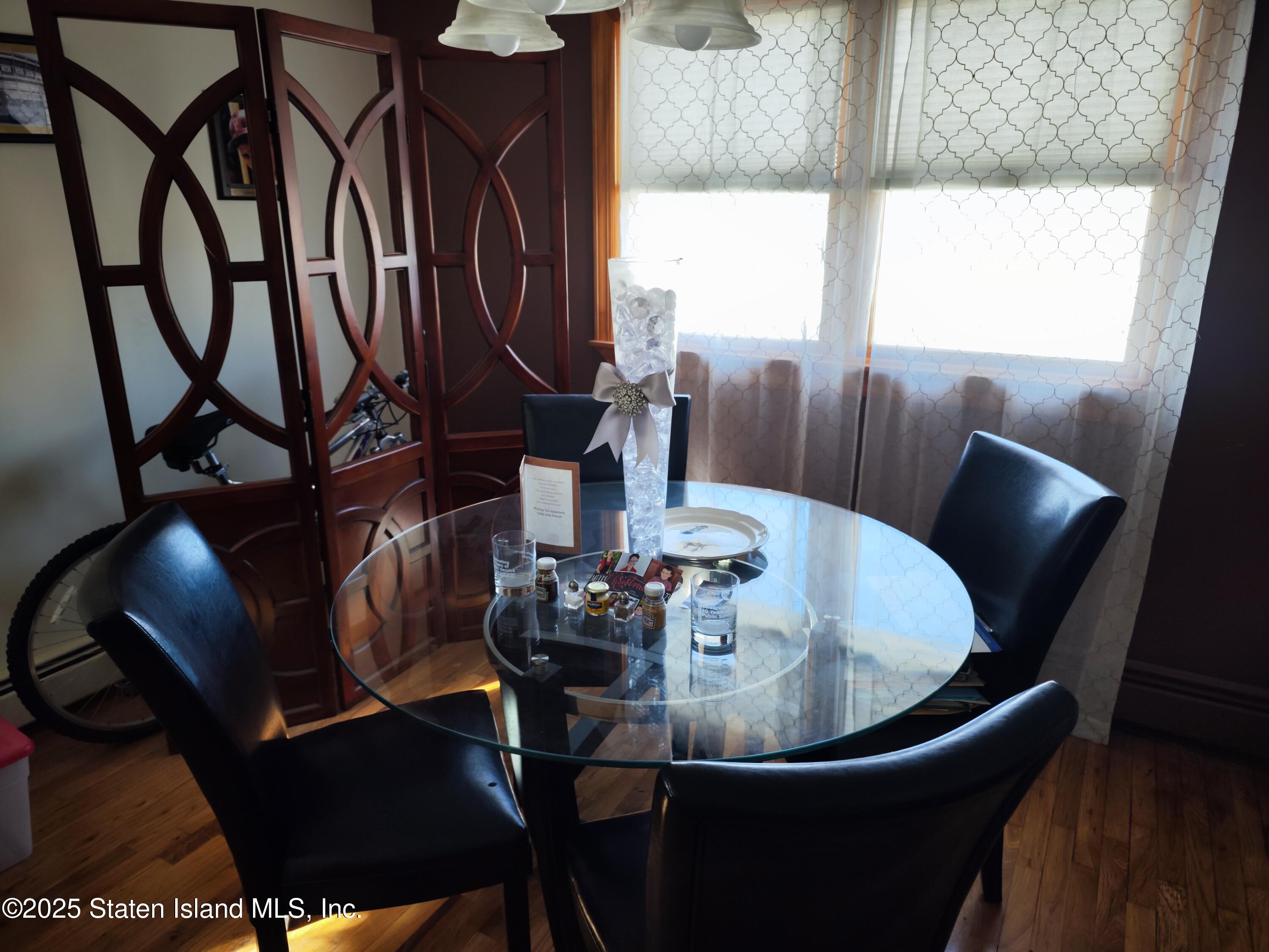 517 Rathbun Avenue Staten Island, NY 10312 - Photo 25 of 28 a view of a dining room with furniture window and wooden floor