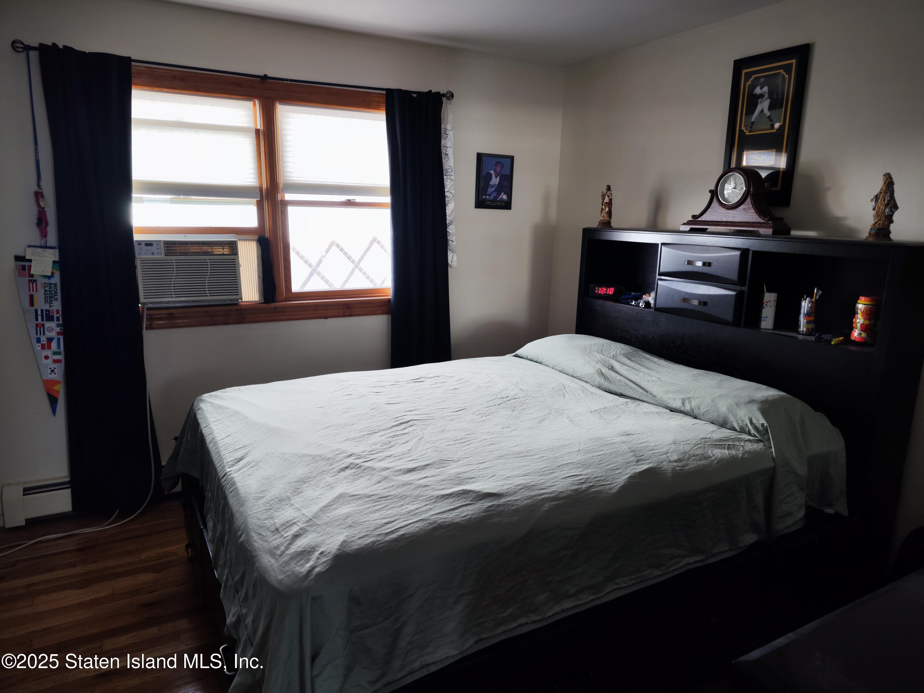517 Rathbun Avenue Staten Island, NY 10312 - Photo 27 of 28 a bedroom with a bed and window