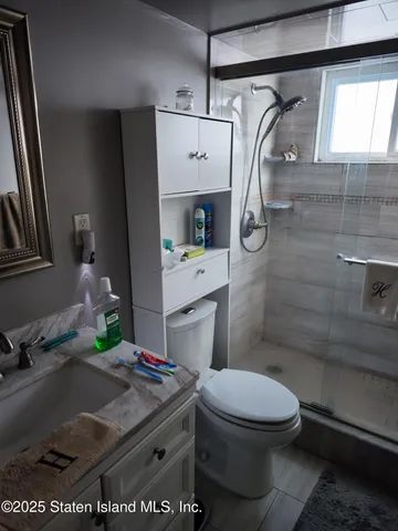 a bathroom with a toilet sink and shower