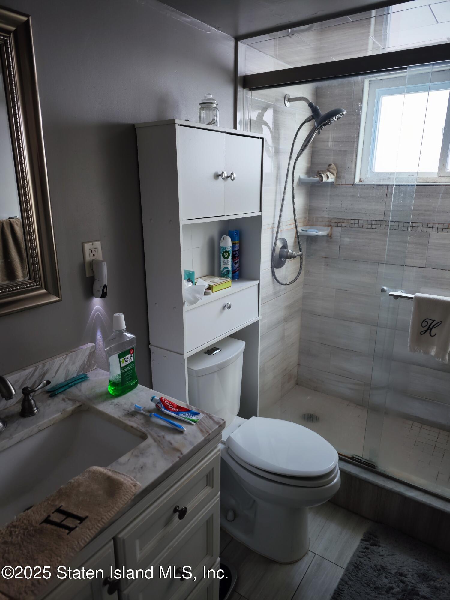 517 Rathbun Avenue Staten Island, NY 10312 - Photo 28 of 28 a bathroom with a toilet sink and shower