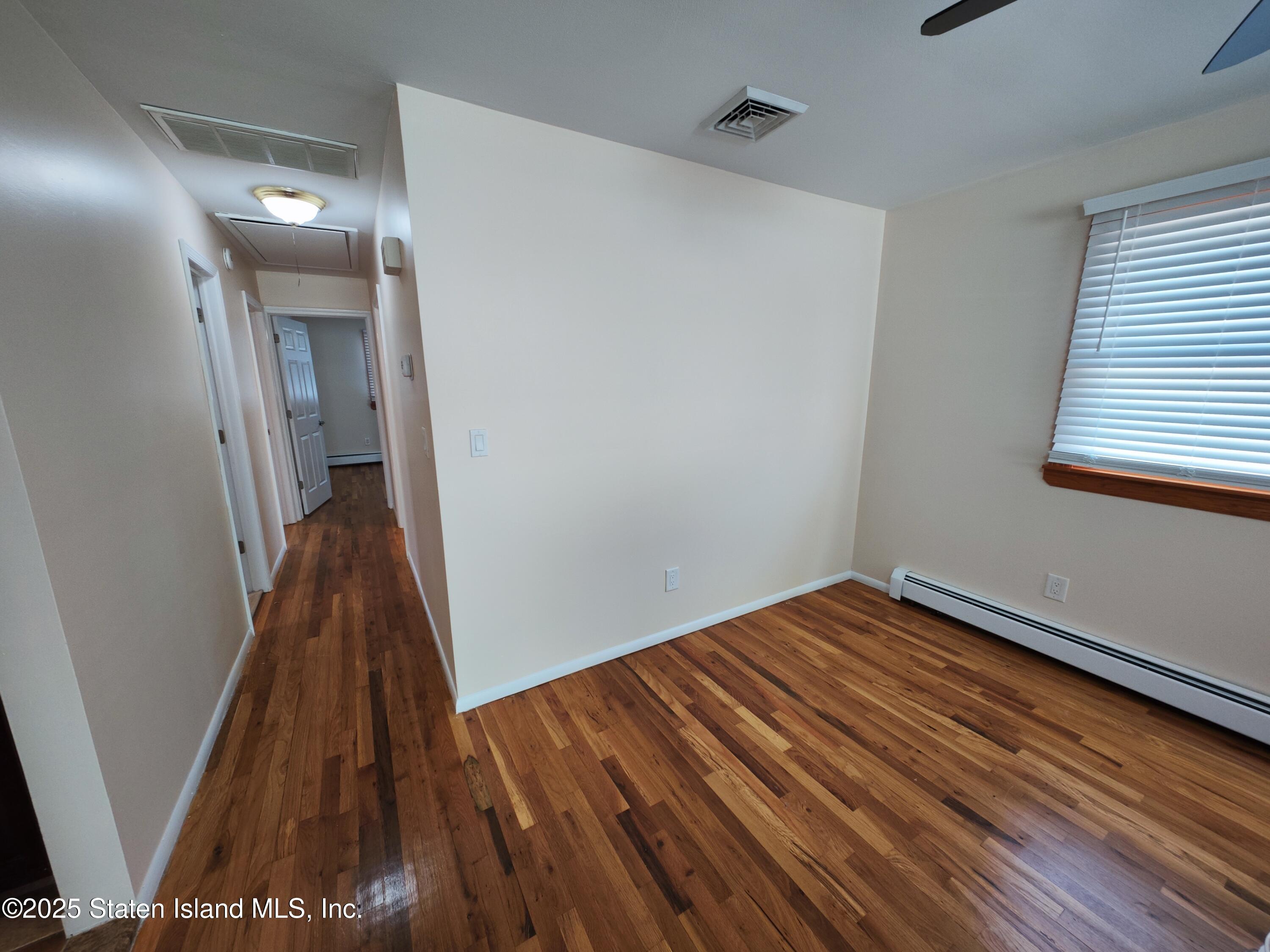517 Rathbun Avenue Staten Island, NY 10312 - Photo 5 of 28 a view of a hallway with wooden floor