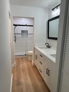 a bathroom with a sink a mirror and shower