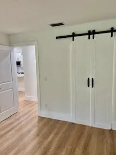 a view of a room with wooden floor