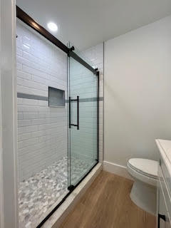 102 Pinecrest Circle, Unit C Jupiter, FL 33458 - Photo 30 of 38 a bathroom with a granite countertop toilet and a shower