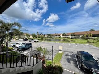 102 Pinecrest Circle, Unit C Jupiter, FL 33458 - Photo 31 of 38 a view of a swimming pool and outdoor seating